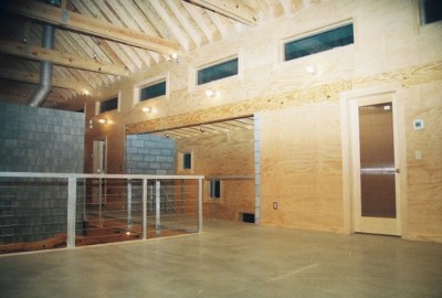 contemporary home with plywood walls and concrete floor