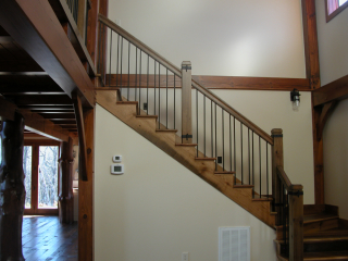 Timber Frame home with stairs of reclaimed wood